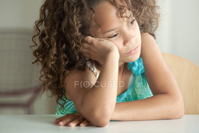Girl leaning on elbow looking away — Stock Photo