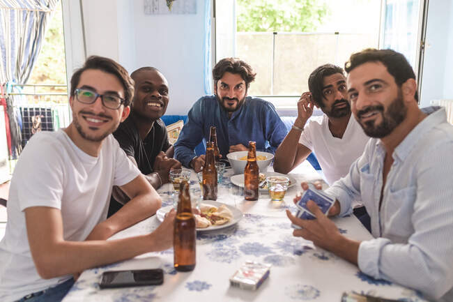 Male friends having card game — Stock Photo