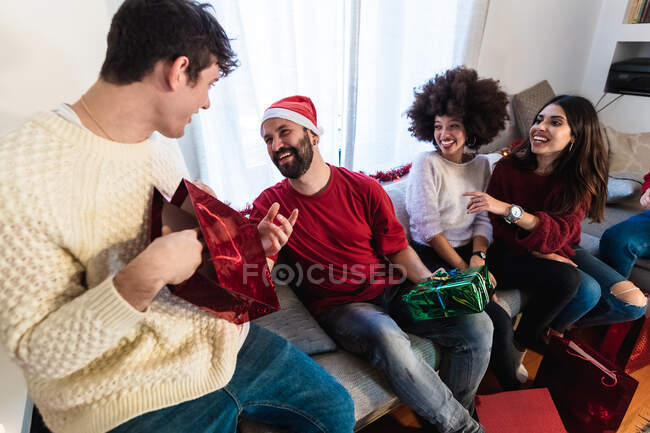 Amigos intercambiando regalos de Navidad - foto de stock