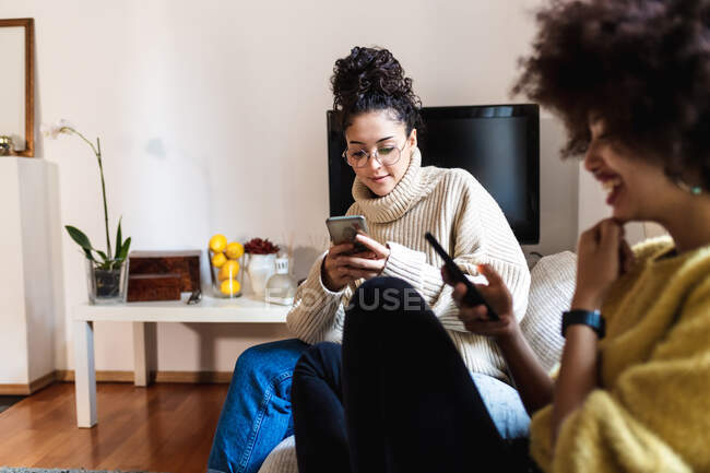 Friends looking at their phones — Stock Photo