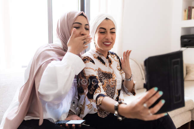 Female friends having video call on tablet — Stock Photo