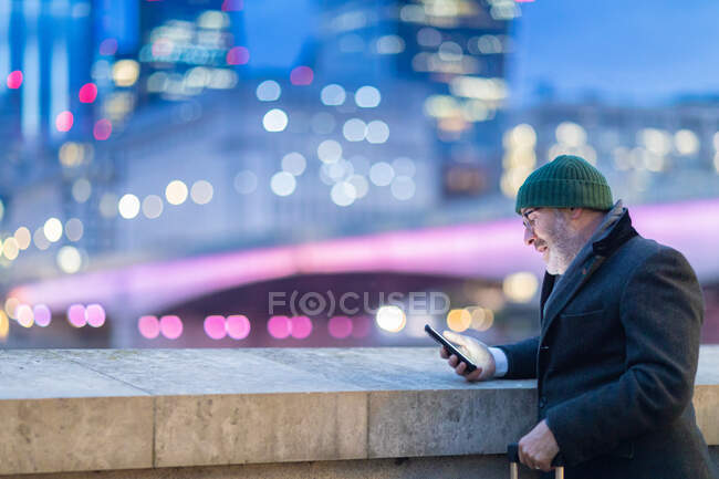 Man in city, looking at phone, London, UK — Stock Photo