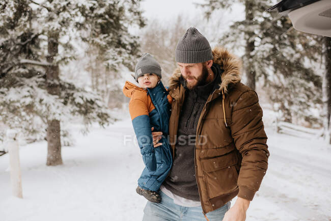 Канада, Онтарио, отец держит мальчика (12-17 месяцев) в зимний день — стоковое фото