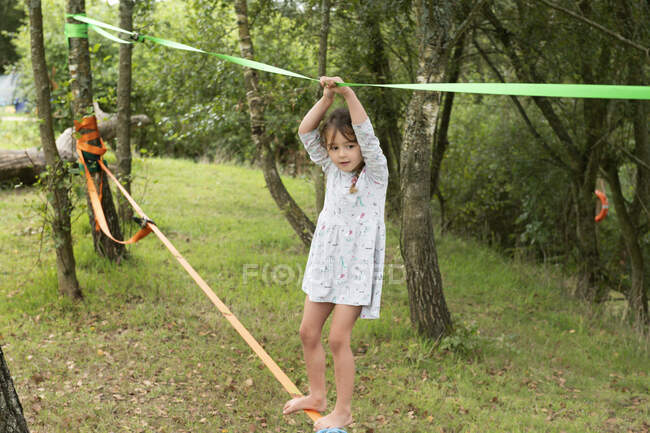 UK, Girl  on slackline in park, close-up view — Stock Photo