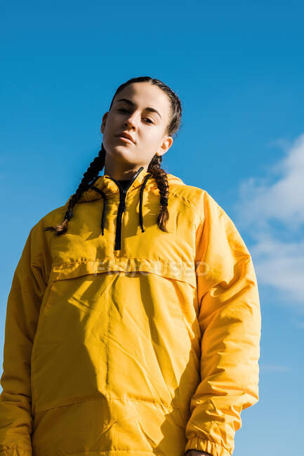 Portrait of teenage (16-17) girl in yellow coat — Stock Photo