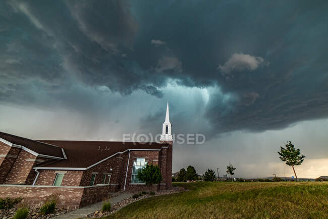 EUA, Colorado, Colorado Springs, nuvens de tempestade tornádica sobre a igreja — Fotografia de Stock