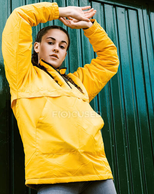 Portrait of teenage (16-17) girl wearing yellow coat — Stock Photo