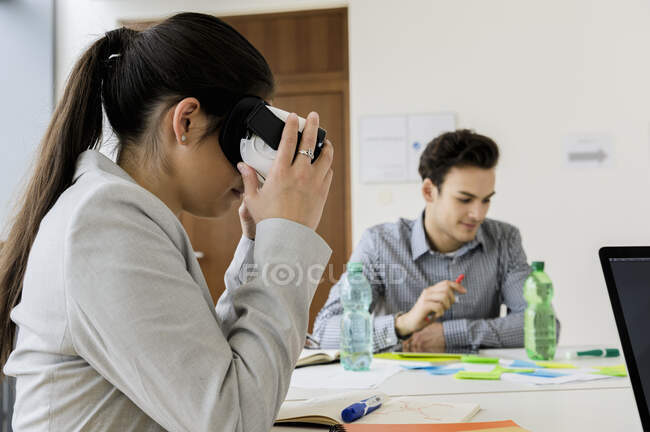 Germany, Bavaria, Munich, Women wearing VR goggles in office — Stock Photo