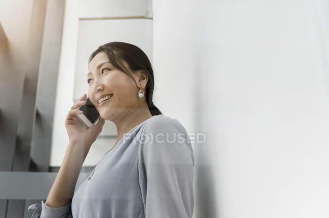 Germany, Bavaria, Munich, Businesswoman talking on smart phone — Stock Photo