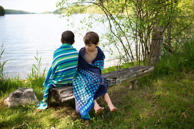 Canada, Ontario, Boys wrapped in towels after swimming — Stock Photo