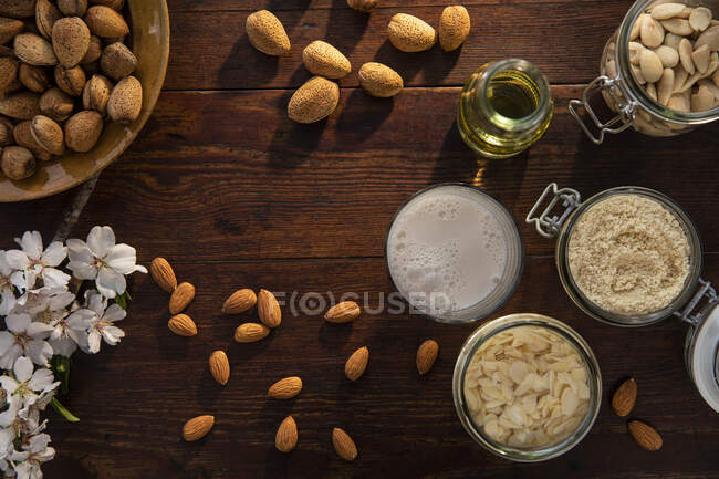 Spain, Baleares, Almonds and almond products on wooden table — Stock Photo