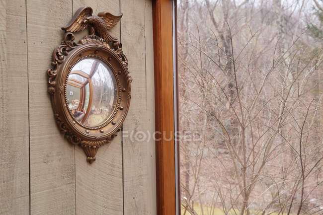 Ornate mirror on house wall — Stock Photo