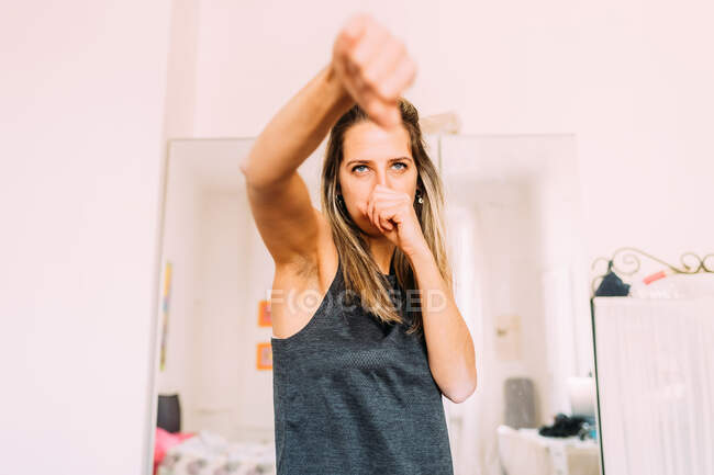 Italy, Young woman exercising at home — Stock Photo