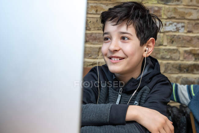 UK, Smiling boy attending online classes — Stock Photo