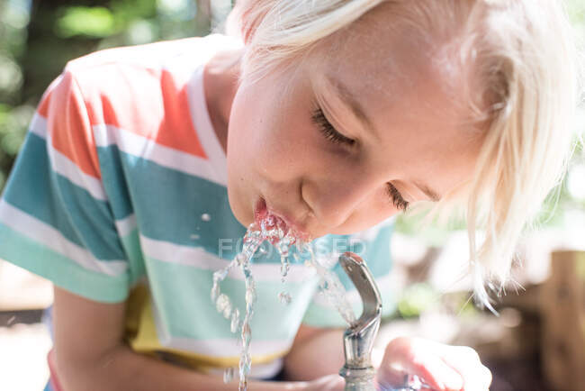 США, Каліфорнія, Біг Сур, хлопчик п'є з фонтану для пиття в парку. — стокове фото