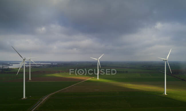 Nederland, Gelderland, Duiven, Aerial view of wind turbines in fields — Stock Photo