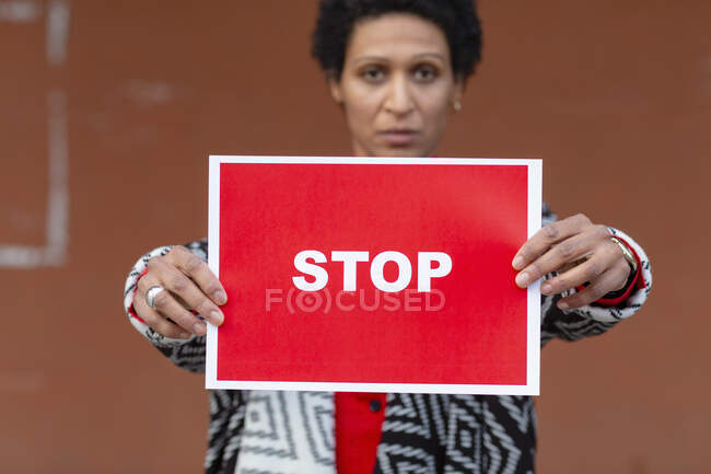 Italy, Tuscany, Pistoia, Woman holding stop sign — Stock Photo