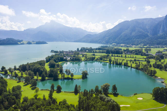 Austria, Salzburg, Aerial view of Mondsee lake and golf course — Stock Photo