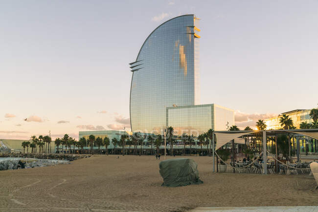 Spain, Barcelona, Beach and Hotel Vela at sunset — Stock Photo