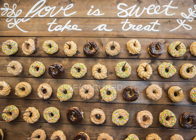 Donuts on wooden wall — Stock Photo