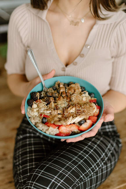 Woman holding granola bowl — Stock Photo