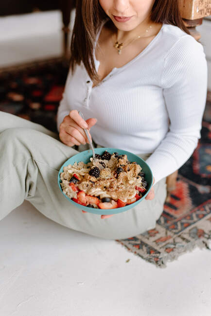 Young woman holding granola bowl — Stock Photo