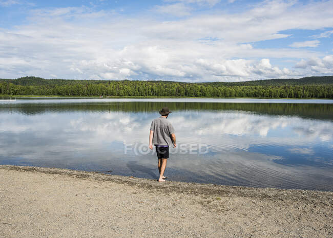 Estados Unidos, Alaska, Vista trasera del hombre a orillas del lago en el Parque Nacional Kenai Fjords - foto de stock