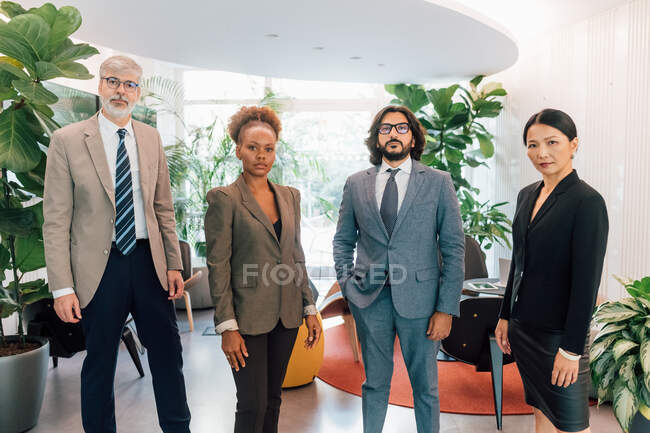 Italy, Portrait of business people standing in creative studio — Stock Photo