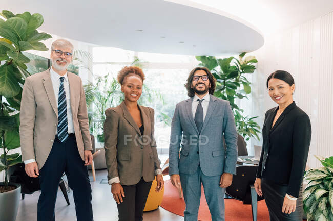 Italy, Portrait of smiling business people standing in creative studio — Stock Photo