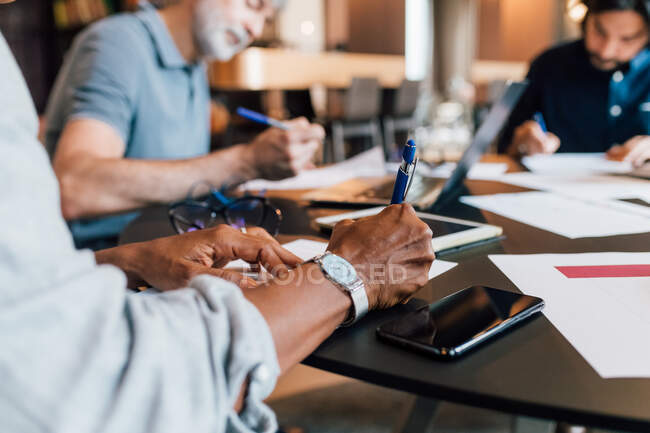 Italy, Close-up of business people having meeting in creative studio — Stock Photo