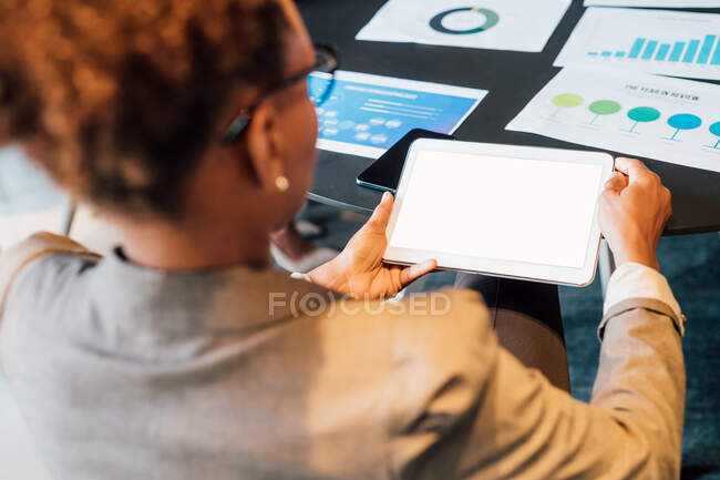 Italy, Businesswoman using digital tablet in creative studio — Stock Photo