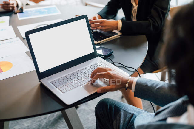 Italy, Business people at table with laptop in creative studio — Stock Photo