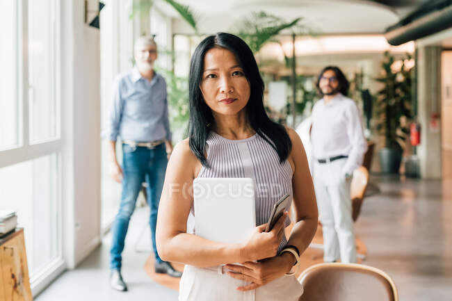 Italy, Portrait of businesswoman with coworkers in creative studio — Stock Photo