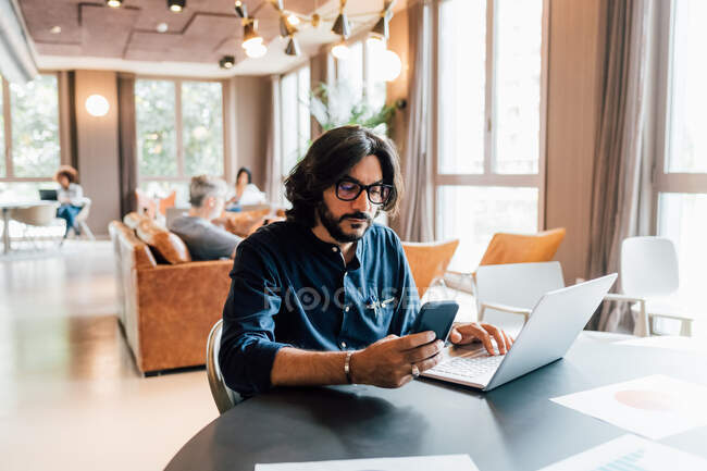 Italy, Man working at table in creative studio — Stock Photo