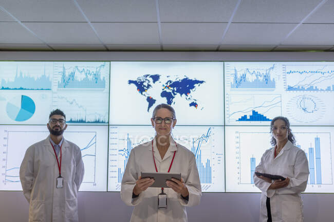 UK, York, Portrait of researchers with digital tablets at interactive screens — Stock Photo