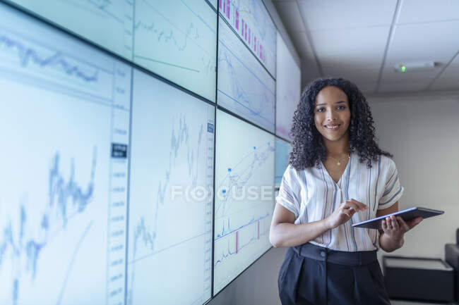 UK, York, Smiling businesswoman with tablet at interactive screens — Stock Photo