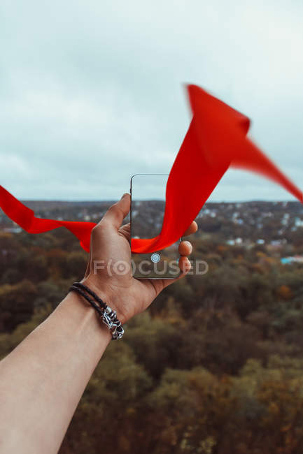 Male hand photographing landscape by smartphone — Stock Photo