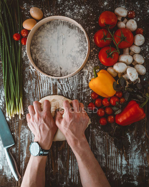 Male hands kneading dough — Stock Photo