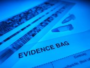DNA samples, autoradiogram and forensic evidence bag on blue background. — Stock Photo