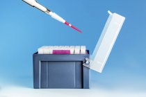 Pipette over medical samples in box. — Stock Photo
