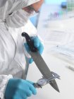 Forensic scientist measuring knife blade as forensic evidence. — Stock Photo