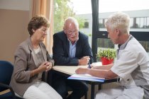 Nurse meeting at hospital consultation with senior patients. — Stock Photo