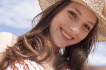 Happy young adult woman in sunhat. — Stock Photo