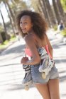 Teenage girl with roller blades looking back. — Stock Photo