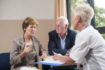 Nurse meeting at hospital consultation with senior patients. — Stock Photo