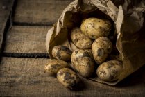 Potatoes in paper bag — Stock Photo
