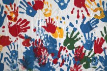 Colorful childish hand prints on white background. — Stock Photo