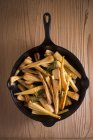 Top view of parsnips in frying pan. — Stock Photo