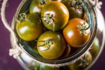Close-up view of camone tomatoes in jar. — Stock Photo