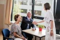 Doctor meeting with senior patients in hospital. — Stock Photo
